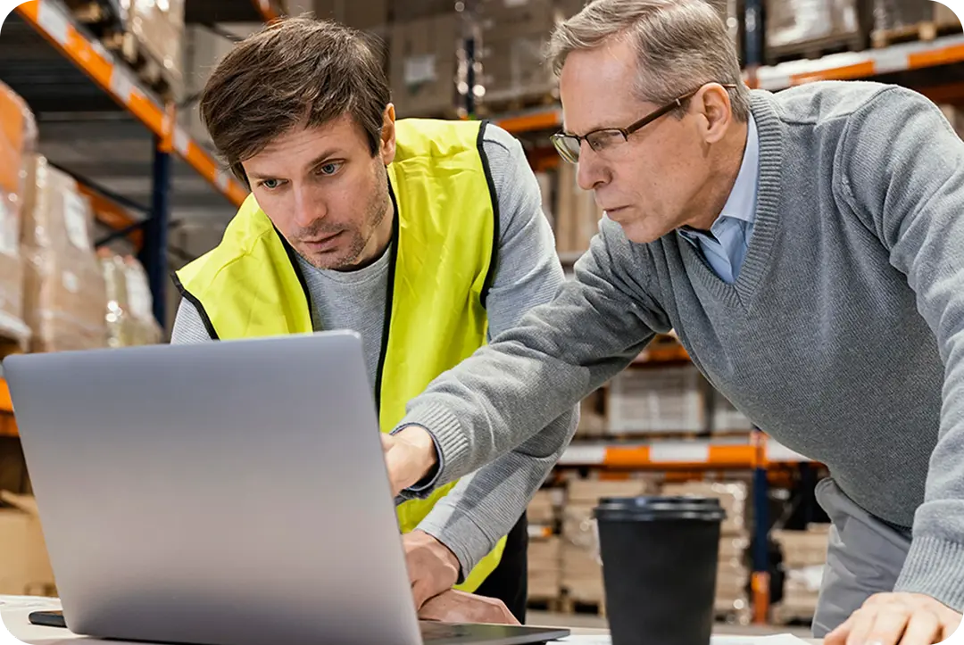 Two men discuss top IT solutions for manufacturing.